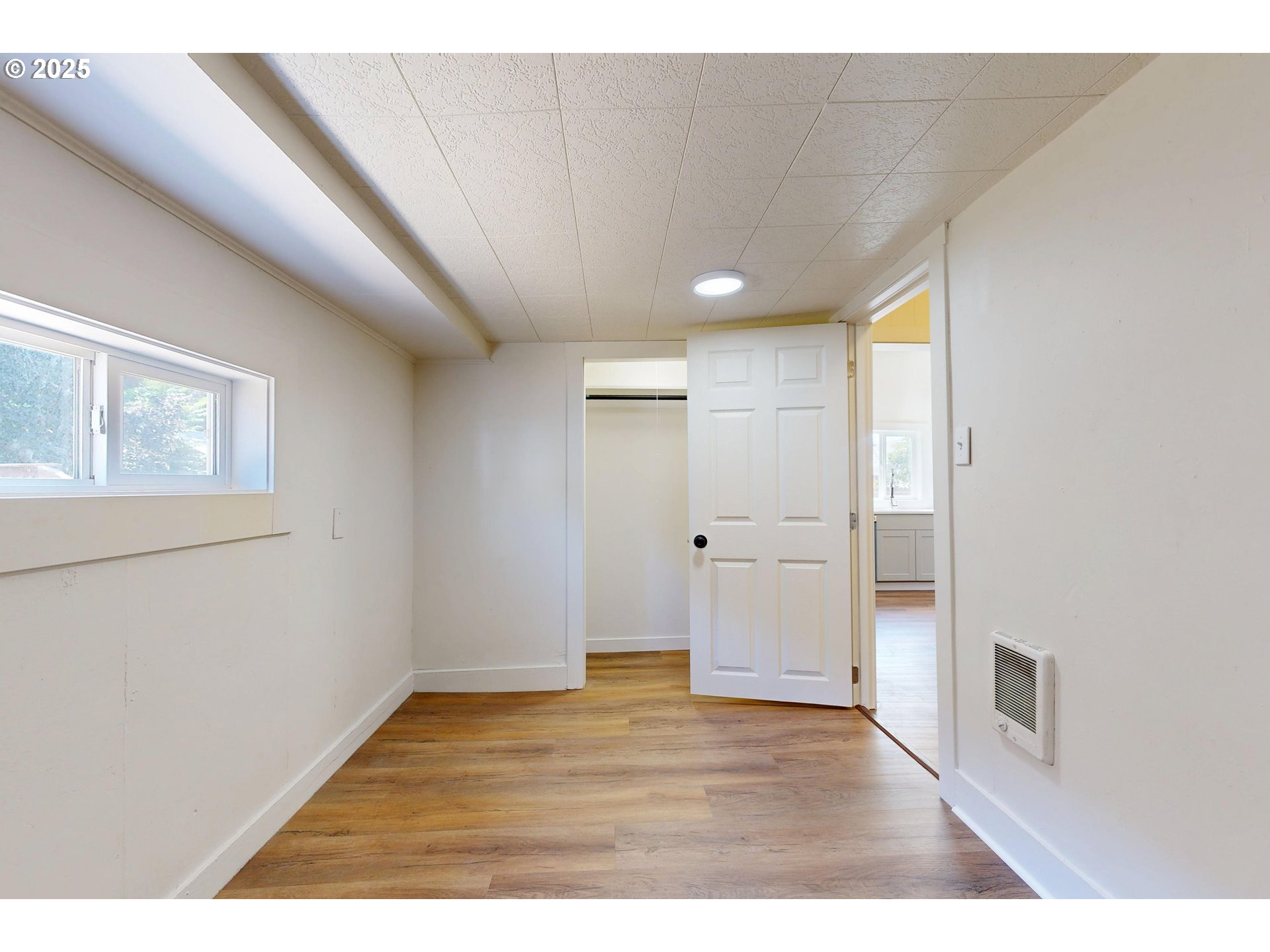 611 Southwest 3rd Street Pendleton, OR 97801 - Photo 14 of 22 a view of an empty room with wooden floor and a window