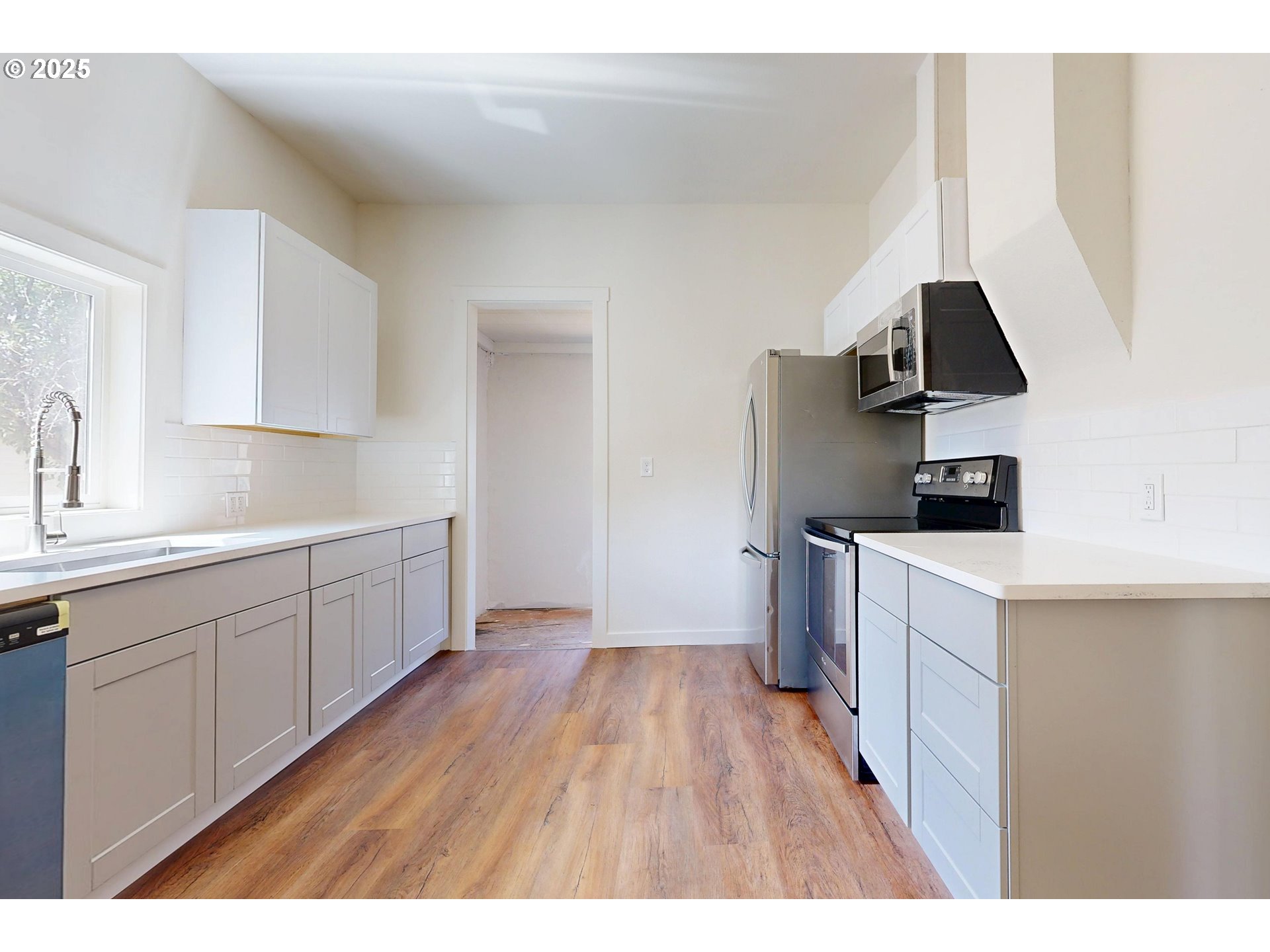 611 Southwest 3rd Street Pendleton, OR 97801 - Photo 6 of 22 a kitchen with a sink and a stove top oven