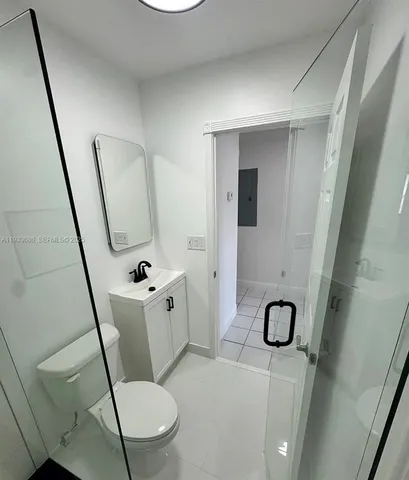 a white toilet sitting next to a sink