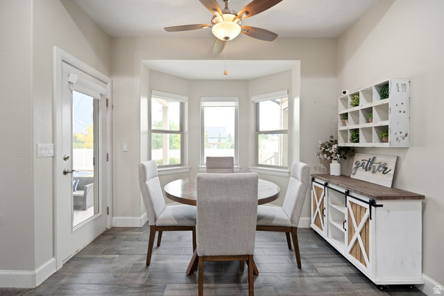 175 West 1000 North Mapleton, UT 84664 - Photo 13 of 42 Dining area featuring a bay window, wood-finish flooring, and a ceiling fan with integrated lighting
