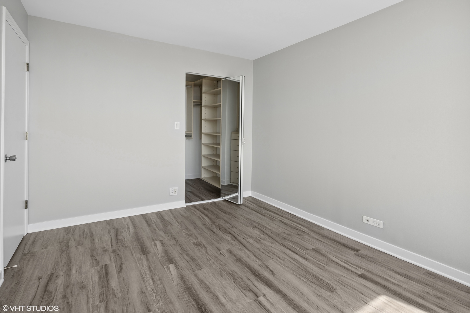 655 West Irving Park Road, Unit 3707 Chicago, IL 60613 - Photo 3 of 13 a view of an empty room with wooden floor and a window