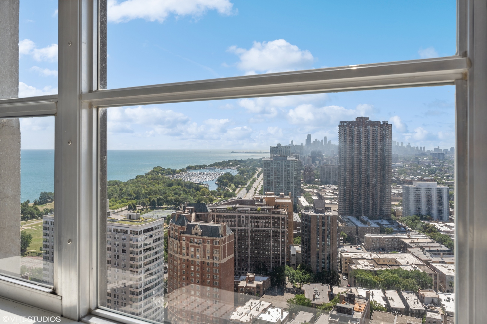 655 West Irving Park Road, Unit 3707 Chicago, IL 60613 - Photo 7 of 13 a view of a balcony with table and chairs