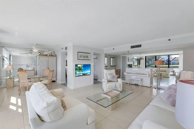 a living room with furniture and view of kitchen