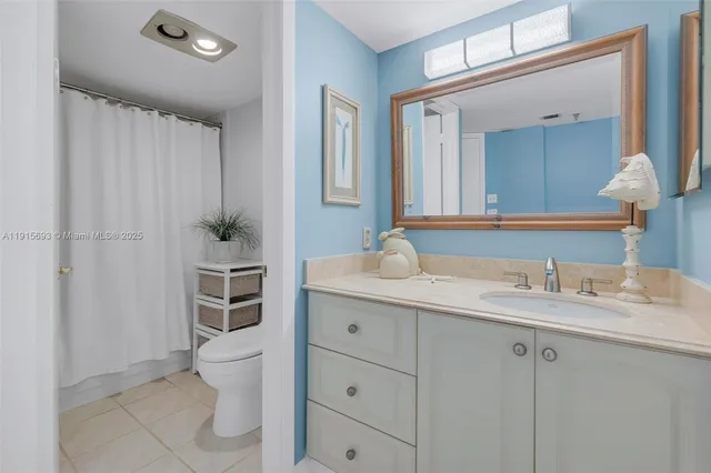 a spacious bathroom with a granite countertop sink mirror and toilet