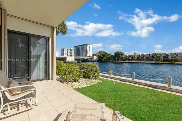 a view of a lake with a garden and barbeque oven