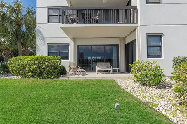 a view of house with backyard porch and outdoor seating
