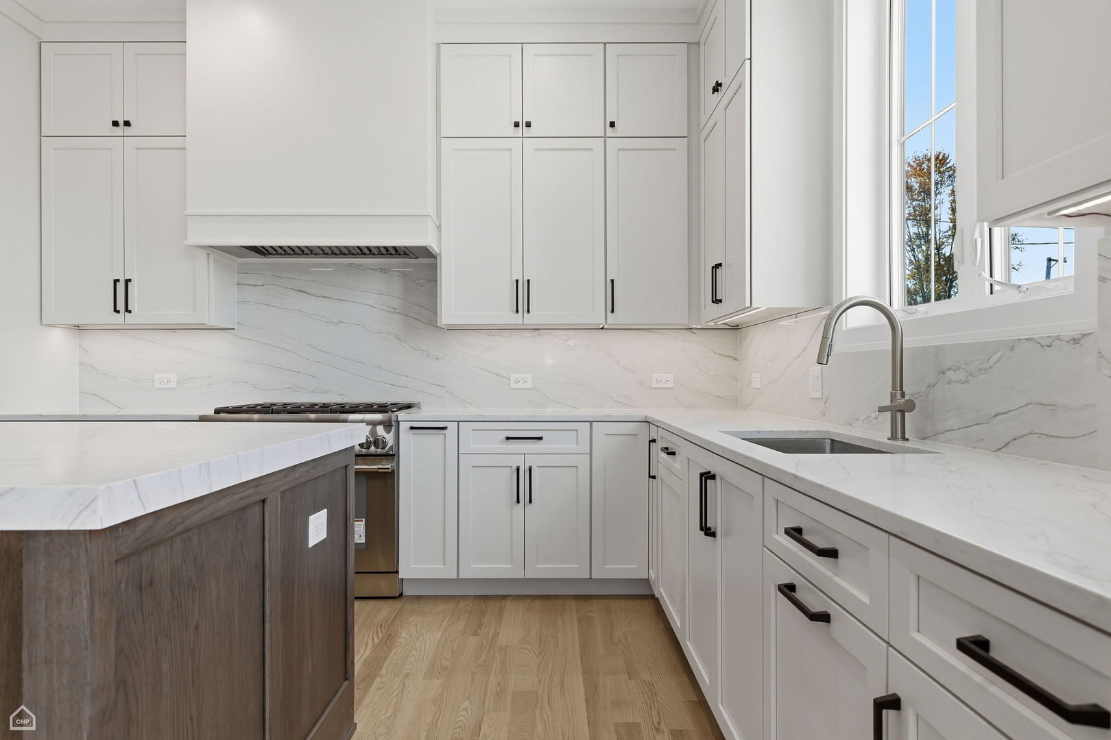 1220 Courtland Avenue Park Ridge, IL 60068 - Photo 12 of 32 a kitchen with white cabinets and a sink