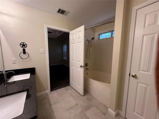 a bathroom with a shower and a sink