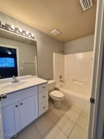 a spacious bathroom with a double vanity sink a mirror and a toilet