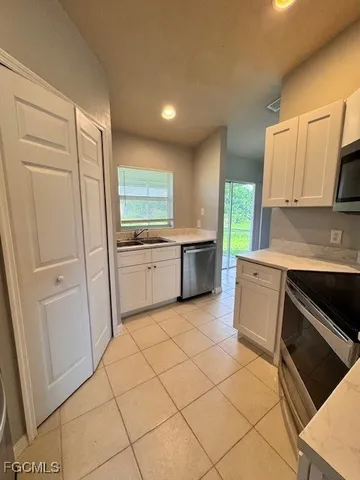 a kitchen with cabinets and appliances