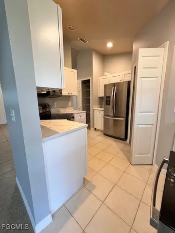 a view of a kitchen with refrigerator and microwave