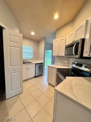 a kitchen with appliances cabinets and furniture