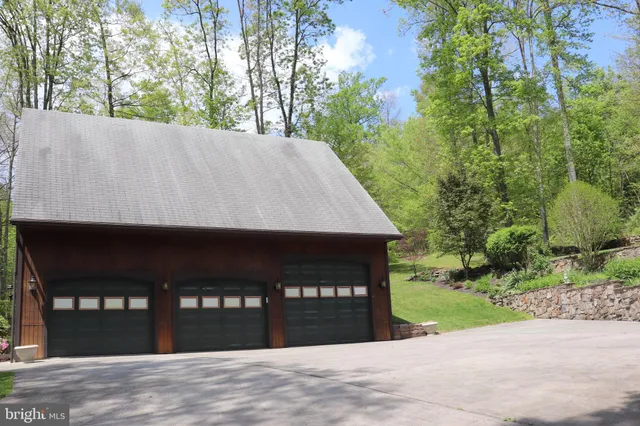 a living room with furniture and floor to ceiling windows