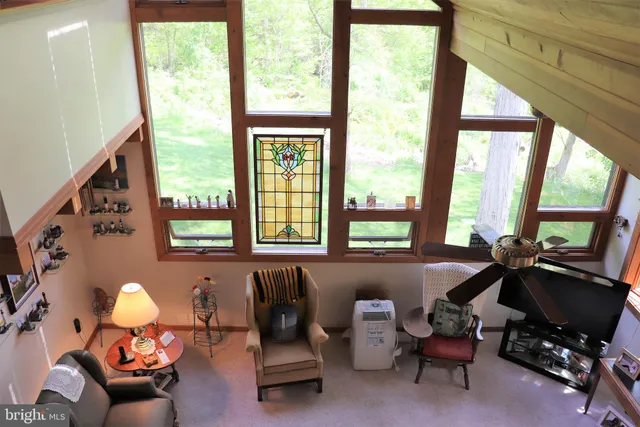 a bedroom with a bed a couch and wall painting