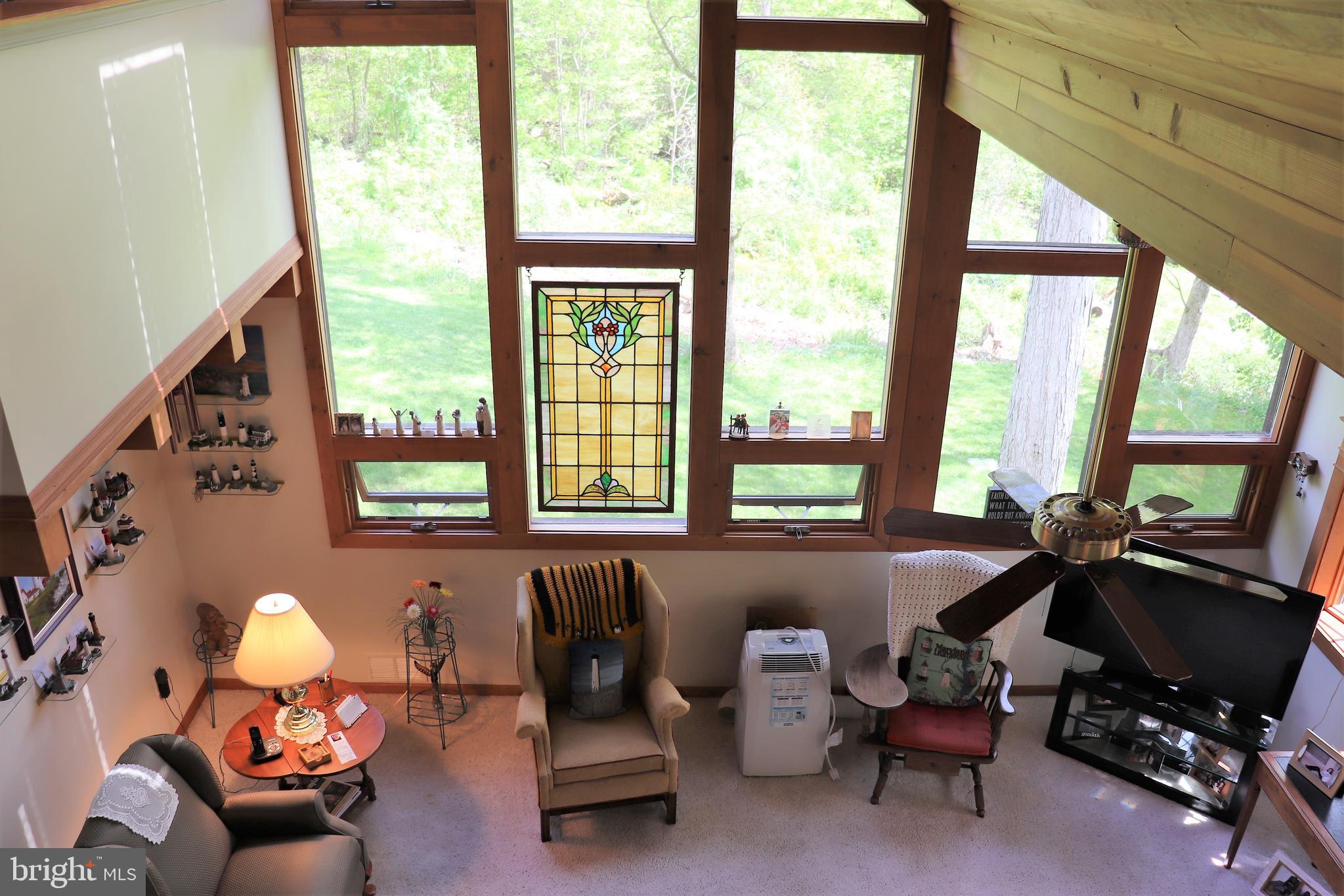 168 Cherry Tree Road Addison, PA 15411 - Photo 13 of 42 a living room with furniture and floor to ceiling windows