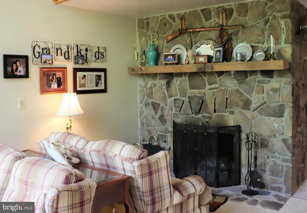 a kitchen with stainless steel appliances kitchen island granite countertop a sink refrigerator and cabinets