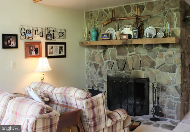 a kitchen with stainless steel appliances kitchen island granite countertop a sink refrigerator and cabinets