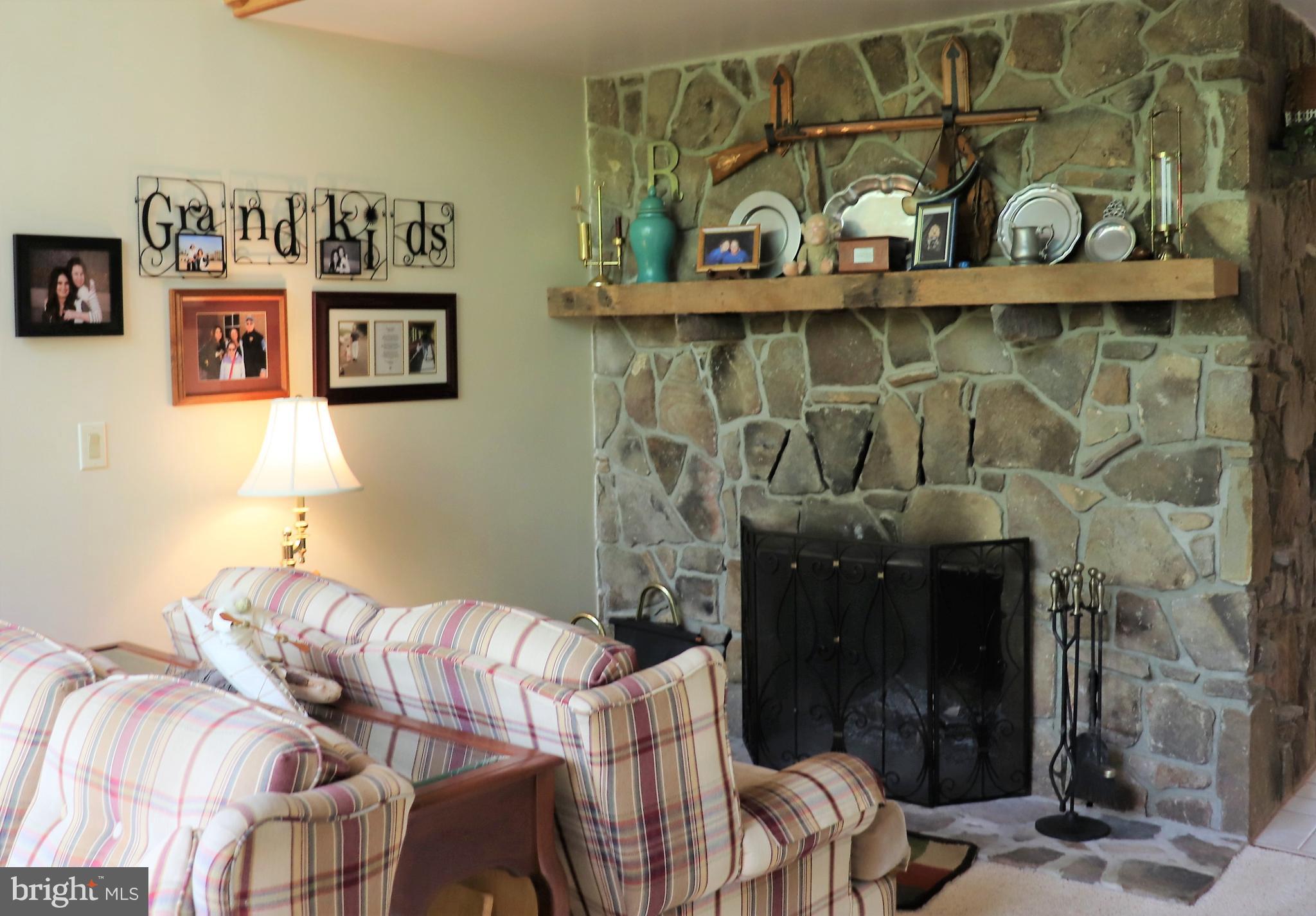 168 Cherry Tree Road Addison, PA 15411 - Photo 15 of 42 a bedroom with a bed a couch and wall painting