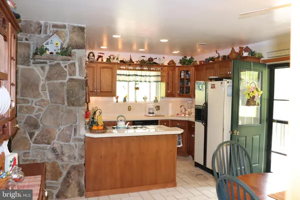 a kitchen with stainless steel appliances granite countertop a refrigerator and a stove