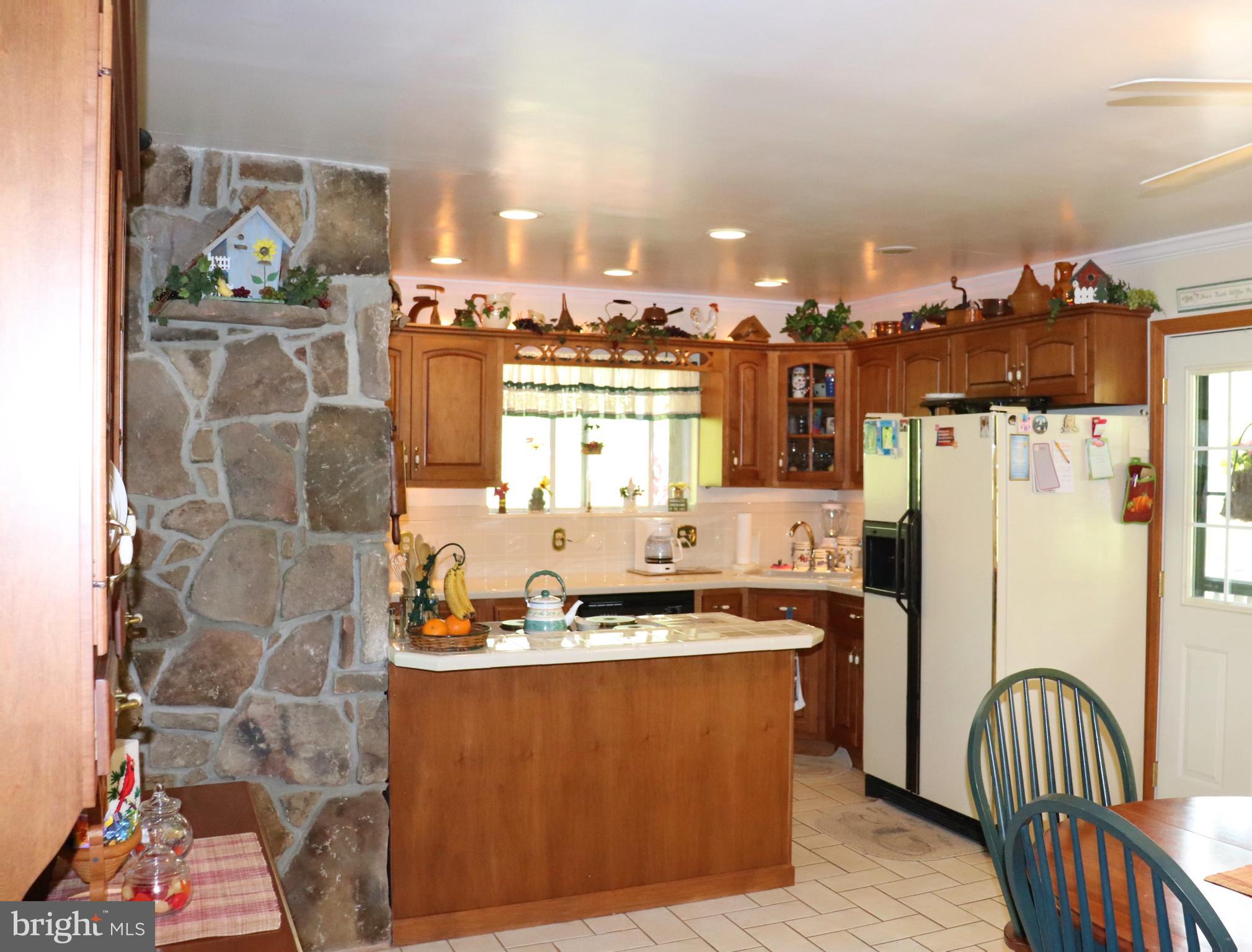 168 Cherry Tree Road Addison, PA 15411 - Photo 18 of 42 a kitchen with stainless steel appliances granite countertop a refrigerator and a stove