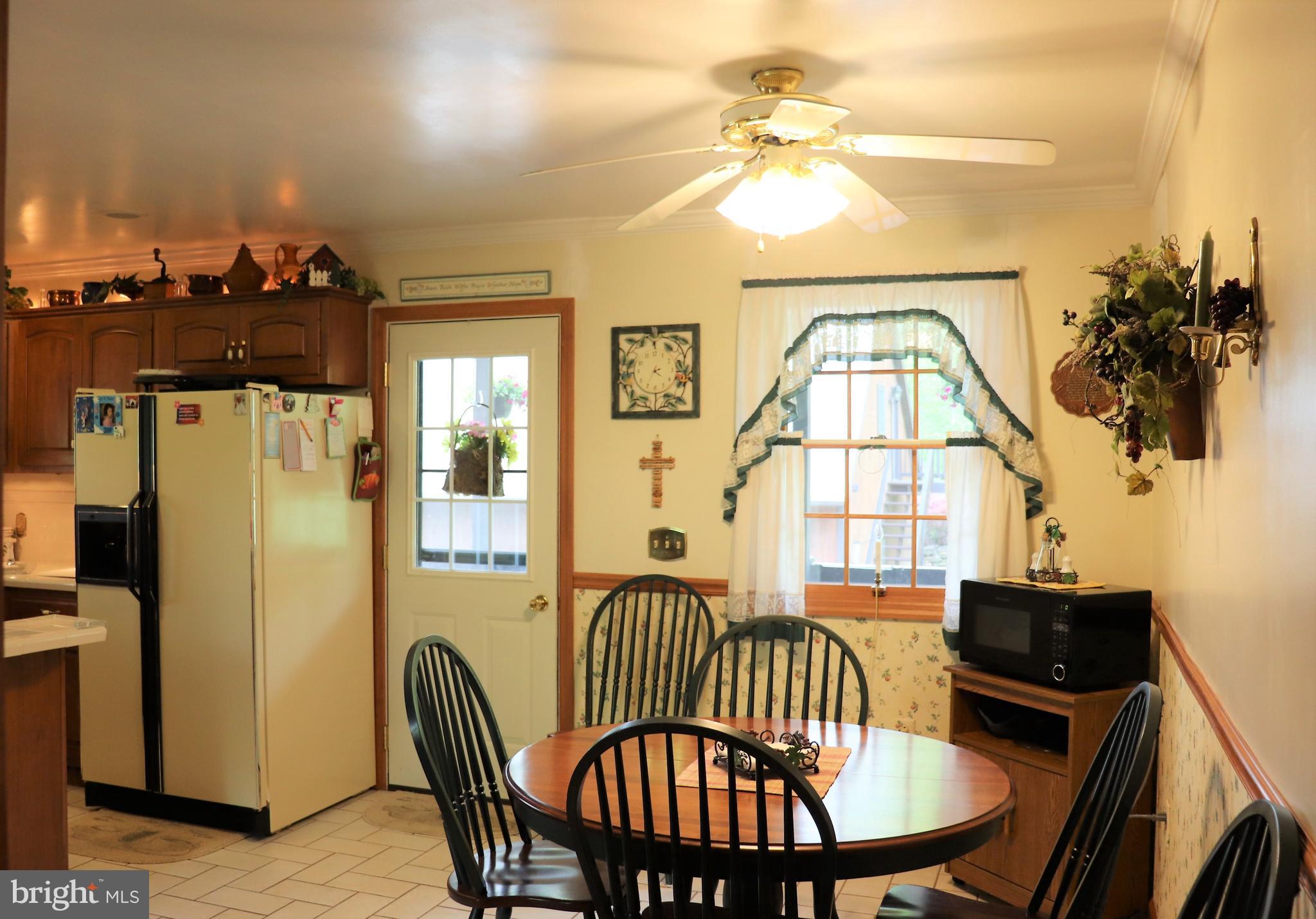 168 Cherry Tree Road Addison, PA 15411 - Photo 19 of 42 a view of a dining room with furniture window and wooden floor