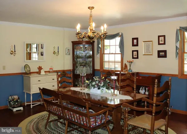 a bedroom with a bed a dresser and mirror