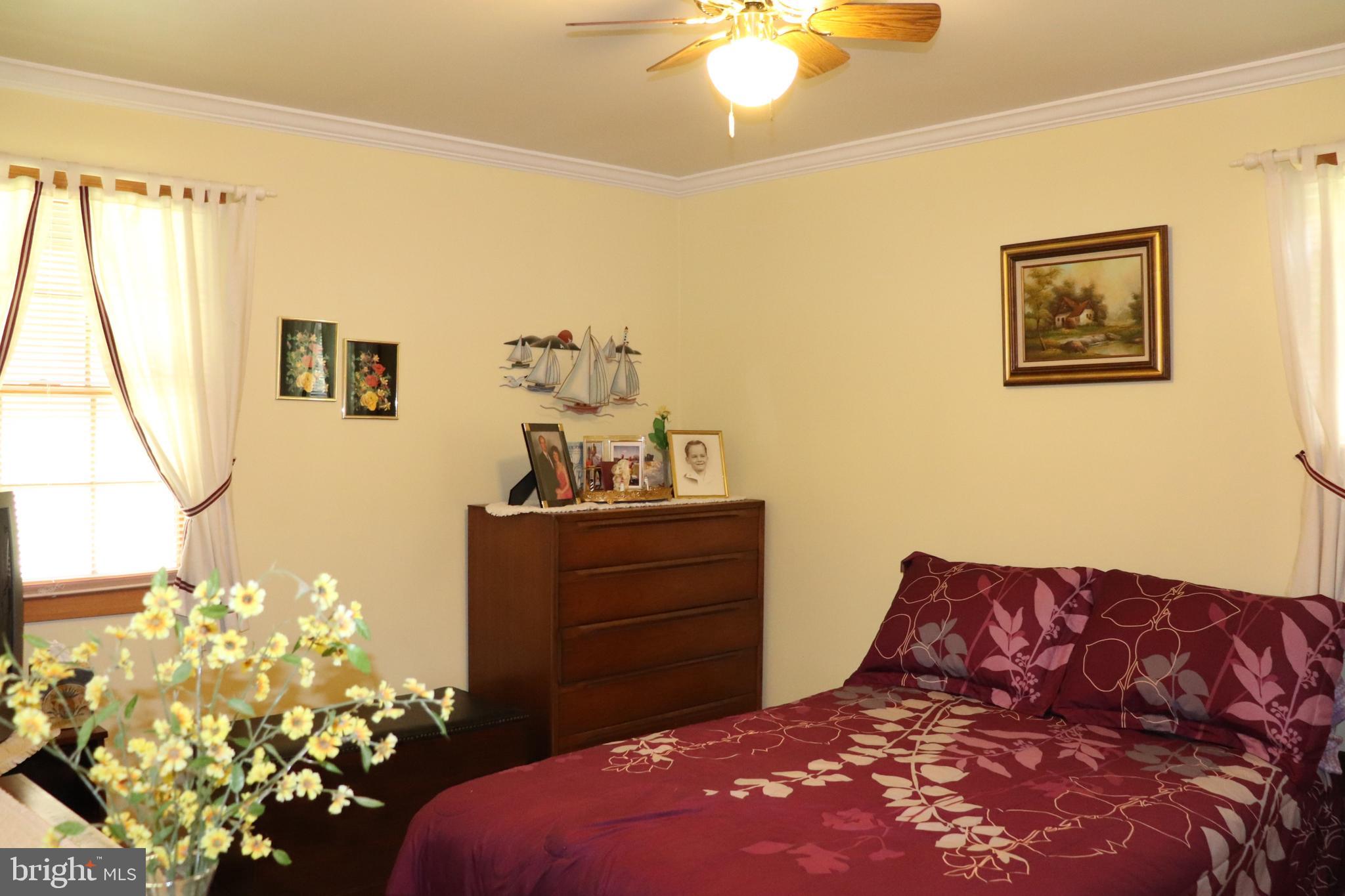168 Cherry Tree Road Addison, PA 15411 - Photo 27 of 42 a bedroom with a bed window and a chandelier