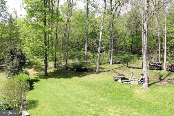 a view of a porch with furniture and garden view