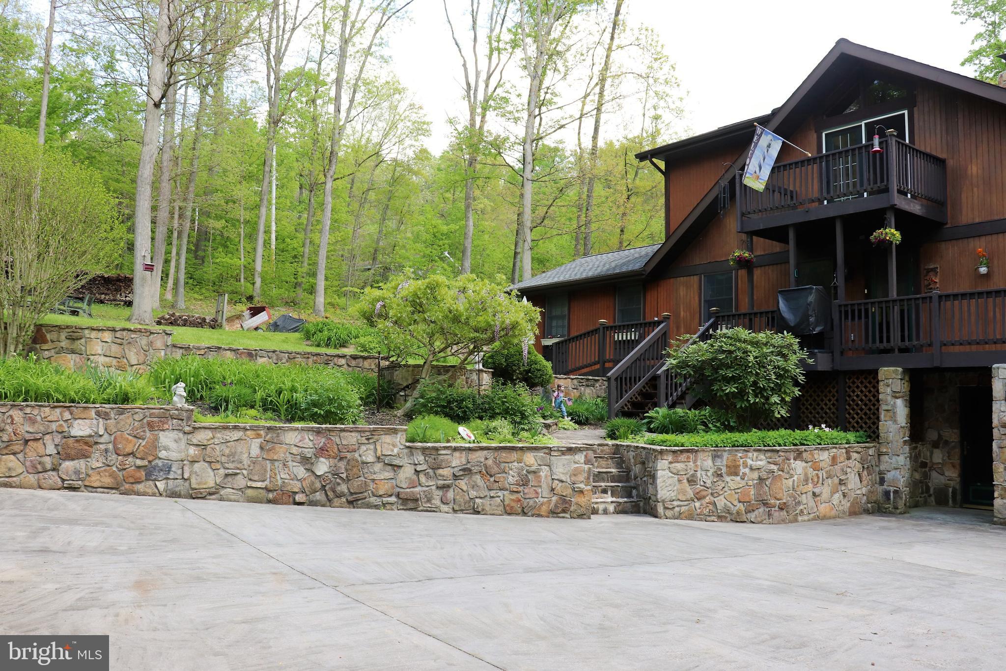 168 Cherry Tree Road Addison, PA 15411 - Photo 39 of 42 a front view of a house with a garden and plants