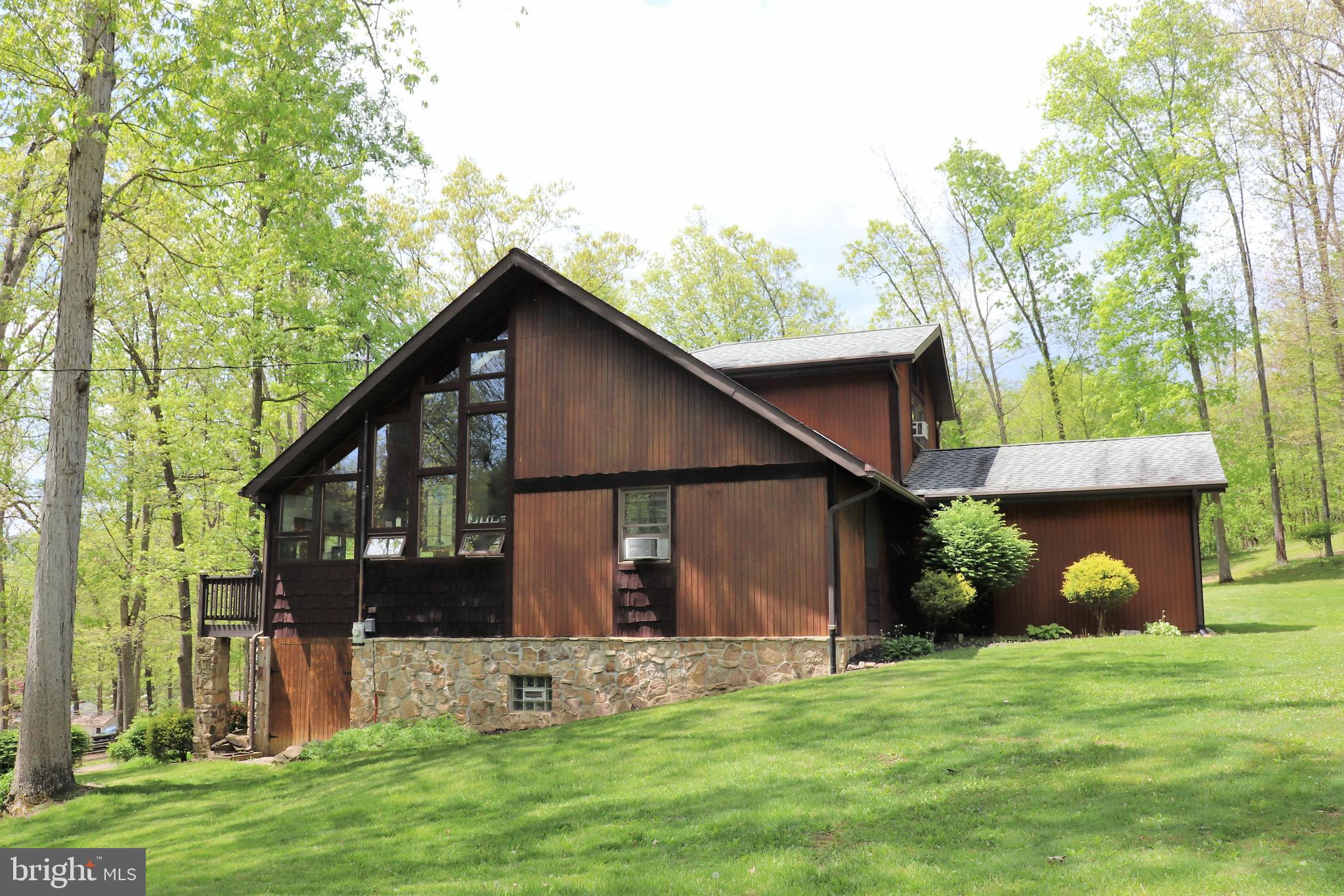 168 Cherry Tree Road Addison, PA 15411 - Photo 6 of 42 a view of a house with a yard and a large tree