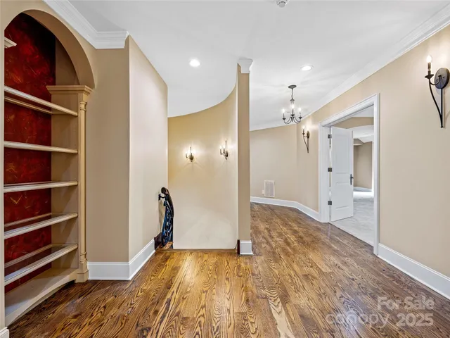 a view of empty room with wooden floor and cabinet