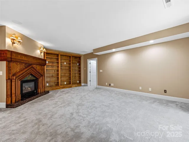 a view of an empty room with fire place