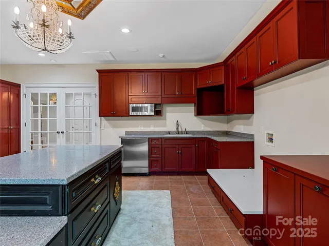 a kitchen with stainless steel appliances granite countertop a stove sink and cabinets