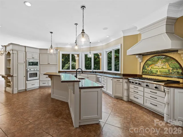 a view of an empty room with a fireplace and a window