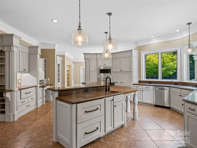 a kitchen with stainless steel appliances granite countertop a stove a sink and a refrigerator