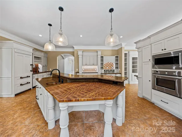 a kitchen with stainless steel appliances granite countertop a stove oven and a refrigerator