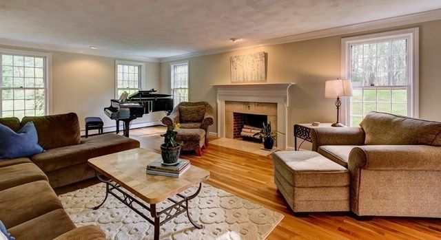 a living room with furniture fireplace and window