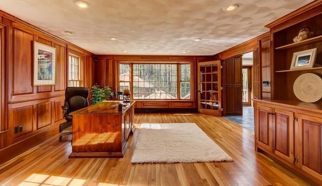 a living room with furniture a large window with wooden floor