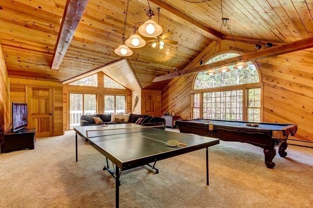 a living room with a table tennis table and a window