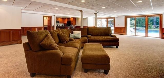 a living room with furniture and large windows