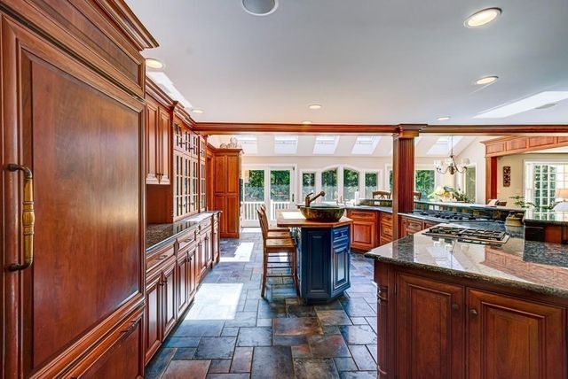 a kitchen with stainless steel appliances granite countertop sink stove and refrigerator