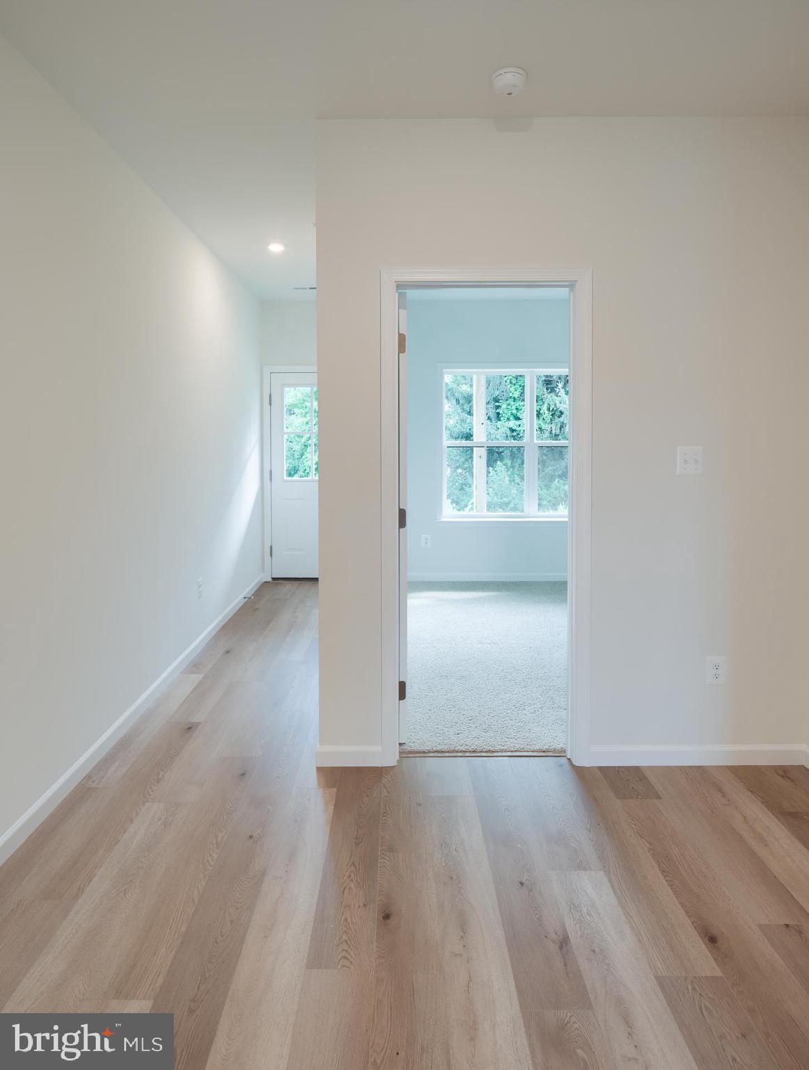 2609 Front Shed Drive Frederick, MD 21702 - Photo 13 of 78 an empty room with wooden floor and windows