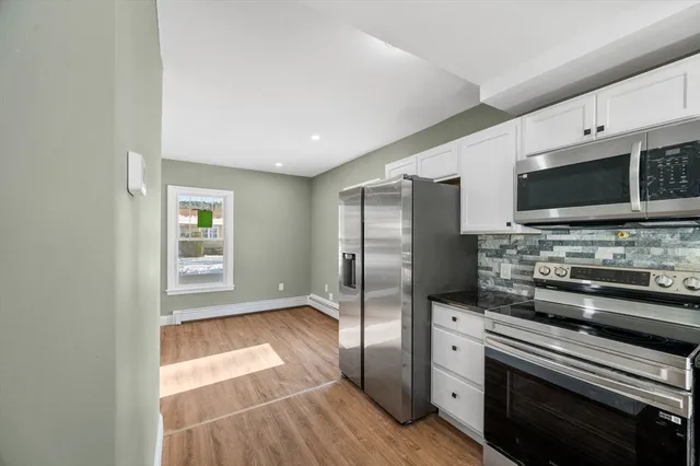 a kitchen with stainless steel appliances a stove microwave and refrigerator