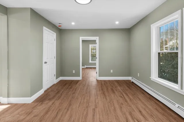 wooden floor in an empty room with a window