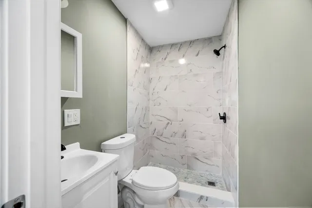 a bathroom with a toilet a sink and a shower