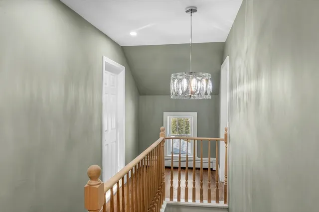 a bedroom with a large bed and a wooden floor