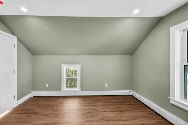 a view of hallway with wooden floor