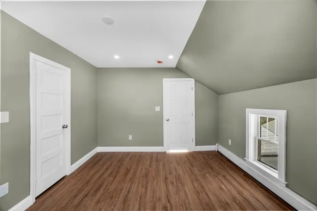 a view of a hallway view with wooden floor and staircase