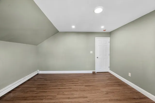 a spacious bedroom with a bed and a window