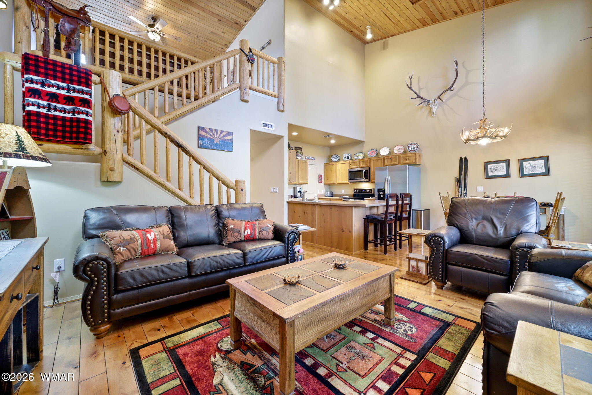 6998 Starlight Ridge Road, Unit LOT 36 Lakeside, AZ 85929 - Photo 3 of 27 a living room with furniture a rug and a chandelier
